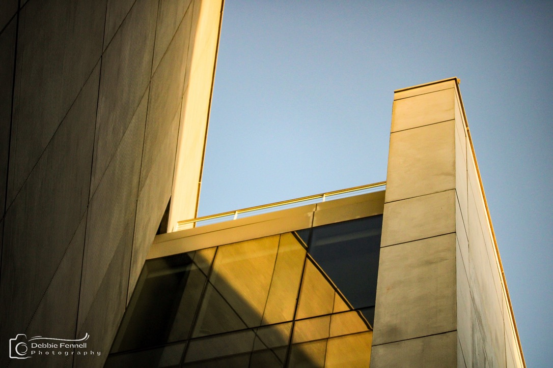Silo District: concrete planes and triangular glazing in warm light