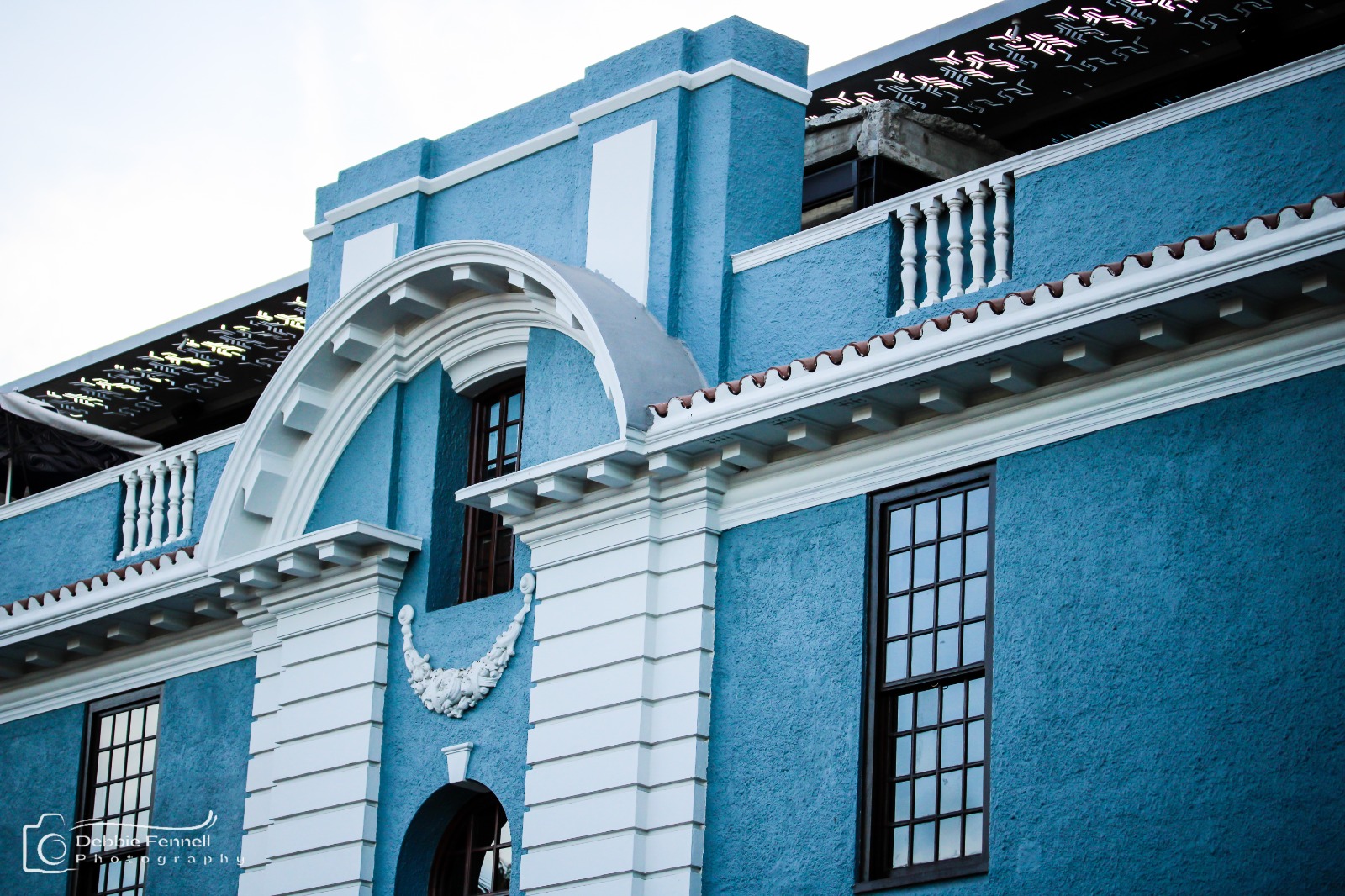 Blue façade, white mouldings and tall windows of the Union Castle Building